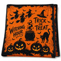 The witch-print throw folded in half on white, showing witches, a cauldron and jack-o'-lanterns