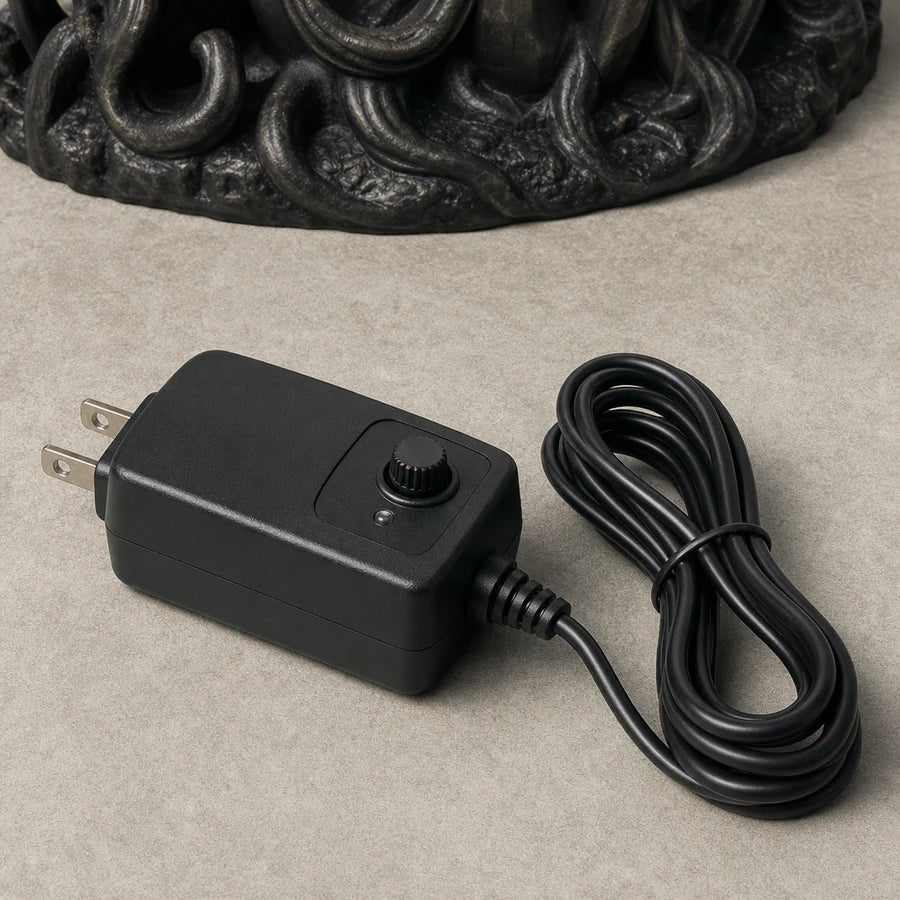 The plug-in power adapter and timer switch at the base of the stand